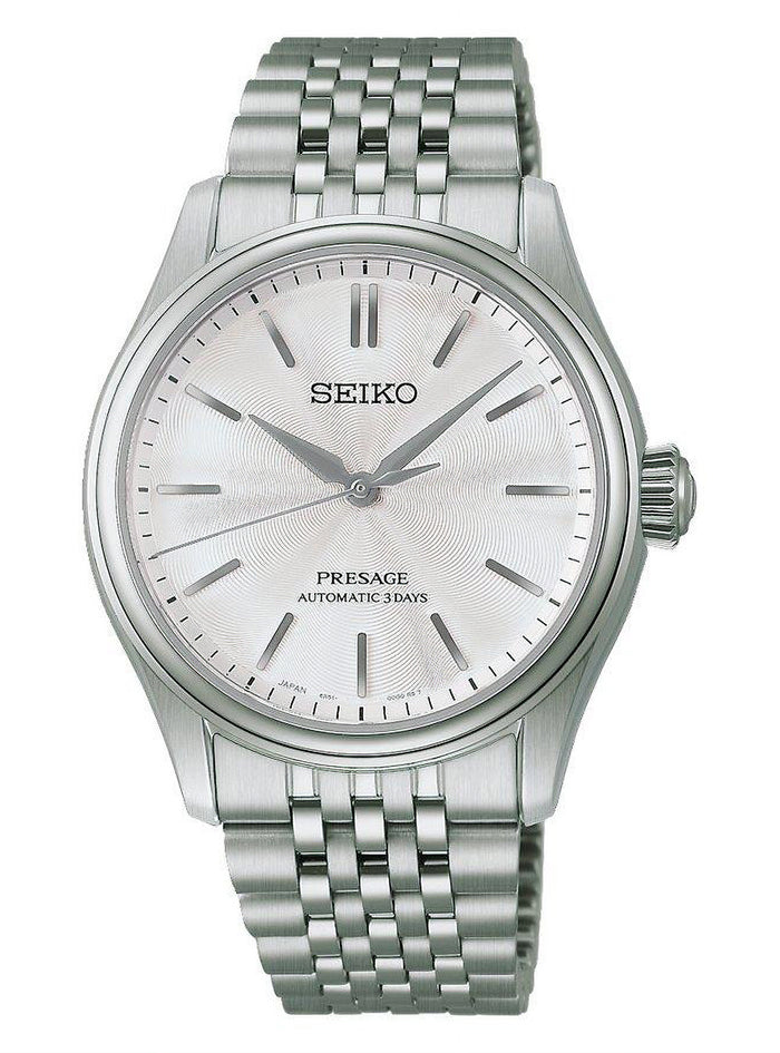 A Seiko Presage automatic watch with a silver stainless steel case and link bracelet, featuring a textured silver dial with simple stick indices.