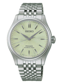 A Seiko Presage automatic watch with a silver stainless steel case and link bracelet, featuring a pale yellow dial with silver-tone baton indices.