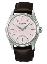A Seiko Presage wristwatch with a silver-tone case, a pale pink dial, and a dark brown leather strap, shown against a plain white background.