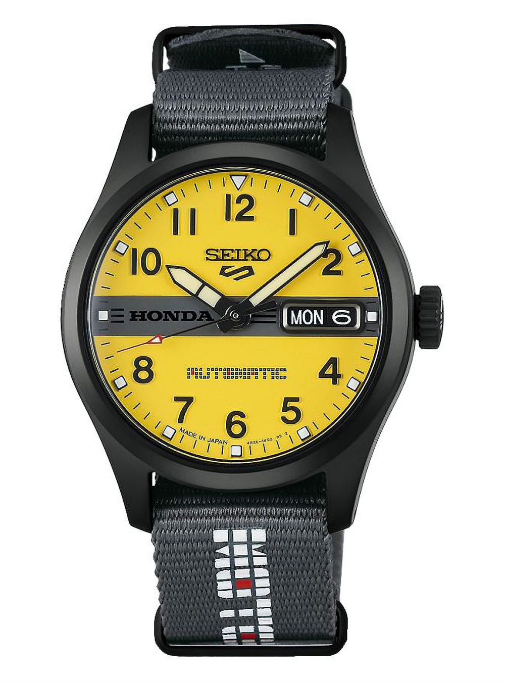A Seiko Honda Automatic watch with a bright yellow dial, black case, and a dark gray woven fabric strap featuring white and red Seiko branding.