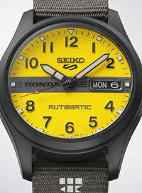 Seiko Honda Automatic watch with a bright yellow dial, black case, and textured gray fabric strap.