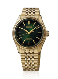 A Seiko Presage automatic watch with a gold-tone metal bracelet and case, featuring a textured dark green dial with gold-tone indices.