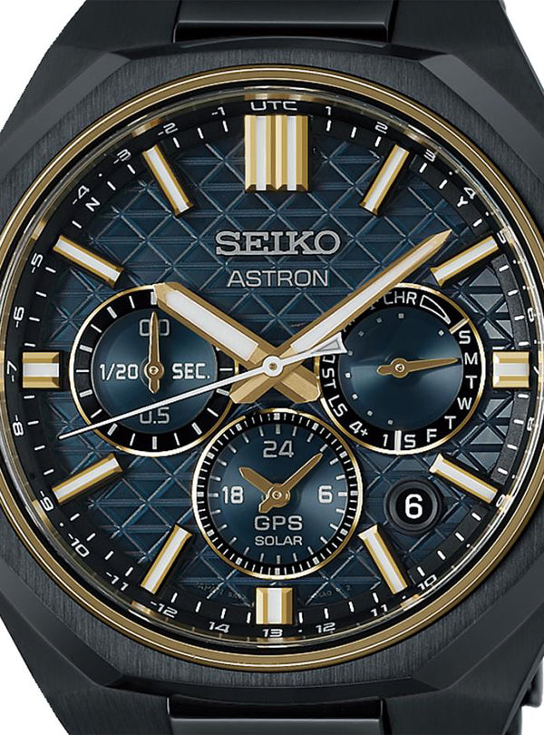 Close-up of a Seiko Astron Solar GPS watch with a black textured dial, gold-tone hands and markers, and a black bezel.