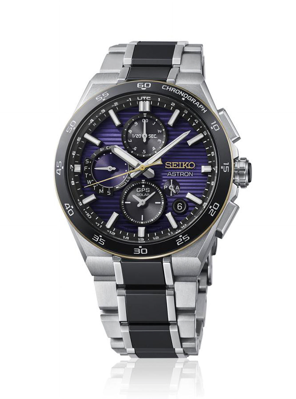 A Seiko Astron chronograph watch with a silver titanium case and link bracelet, featuring a black bezel and a blue-purple sunburst dial with gold accents.