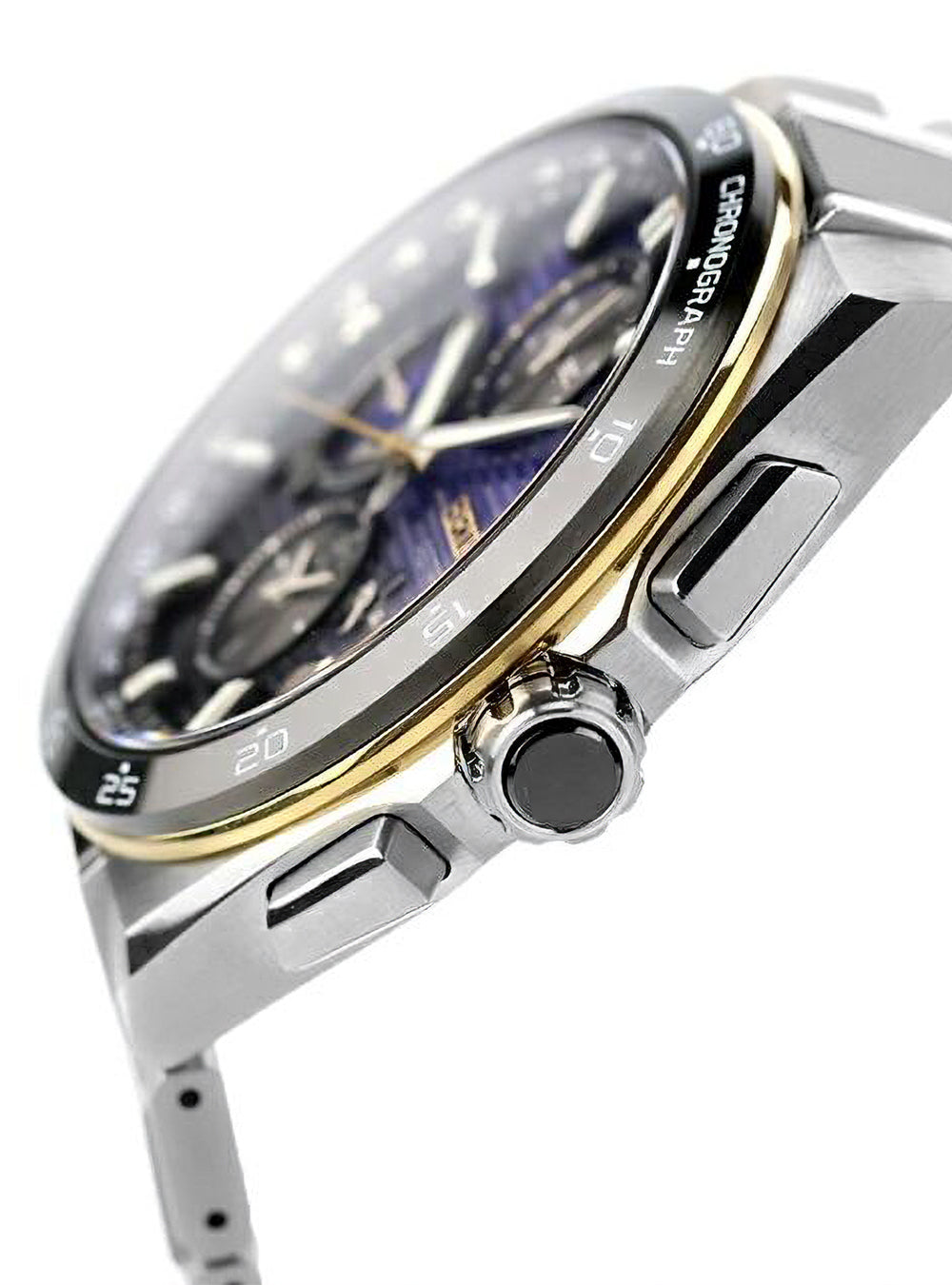 Close-up of a stainless steel chronograph watch with a dark blue dial, gold-tone bezel accents, and a silver metal bracelet on a white background.