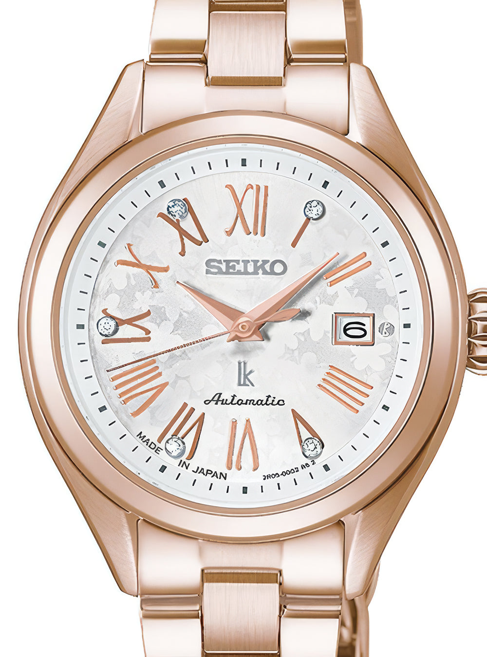 A Seiko women's automatic watch featuring a rose gold-tone metal bracelet and case, a white dial with rose gold Roman numerals and hands, and crystal hour markers.