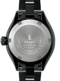Close-up of the back of a Seiko watch with a black case and black metal link bracelet, showing a brushed silver case back with engraved text and logo.